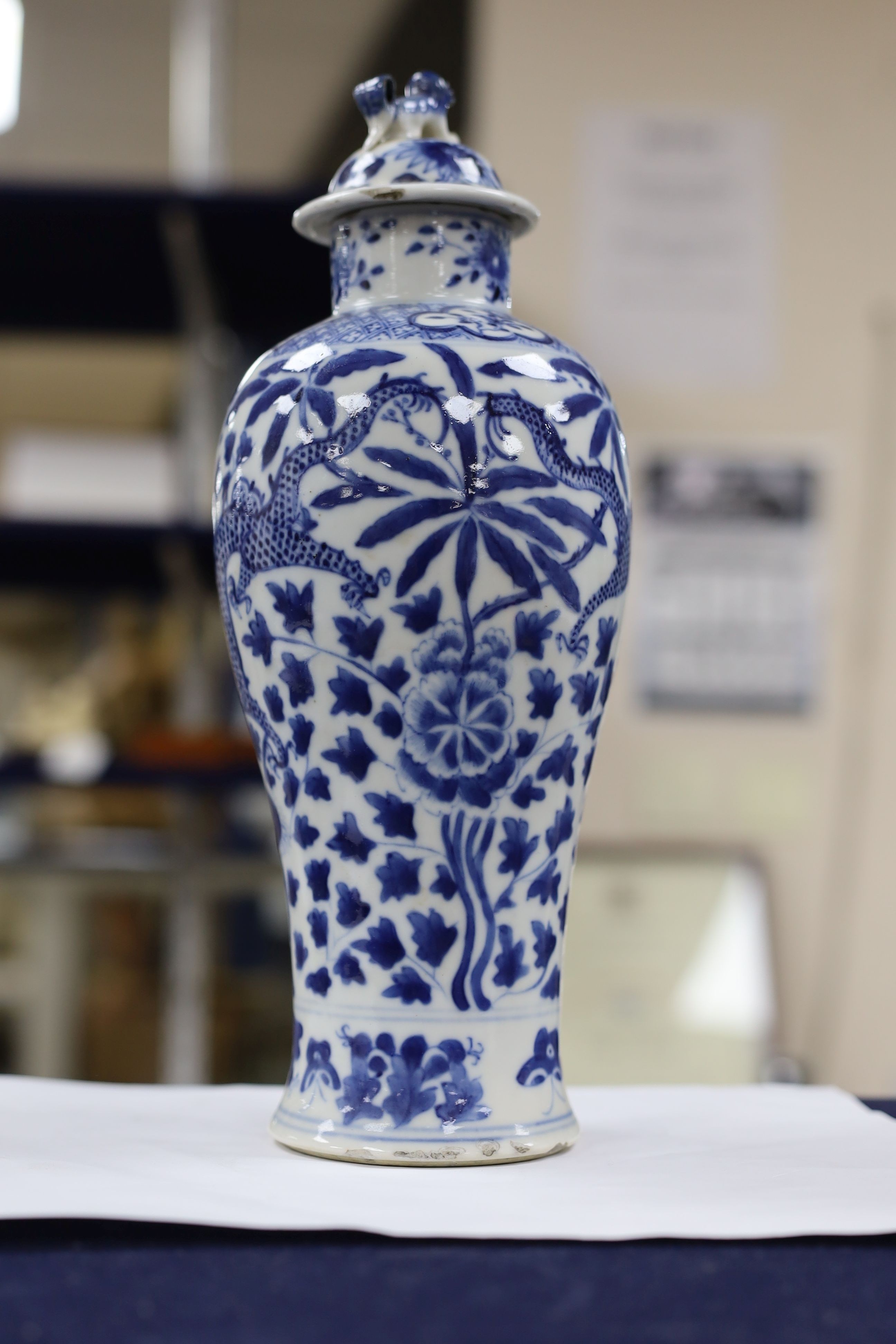 A pair of Chinese blue and white dragon vases and covers, circa 1900. 28cm